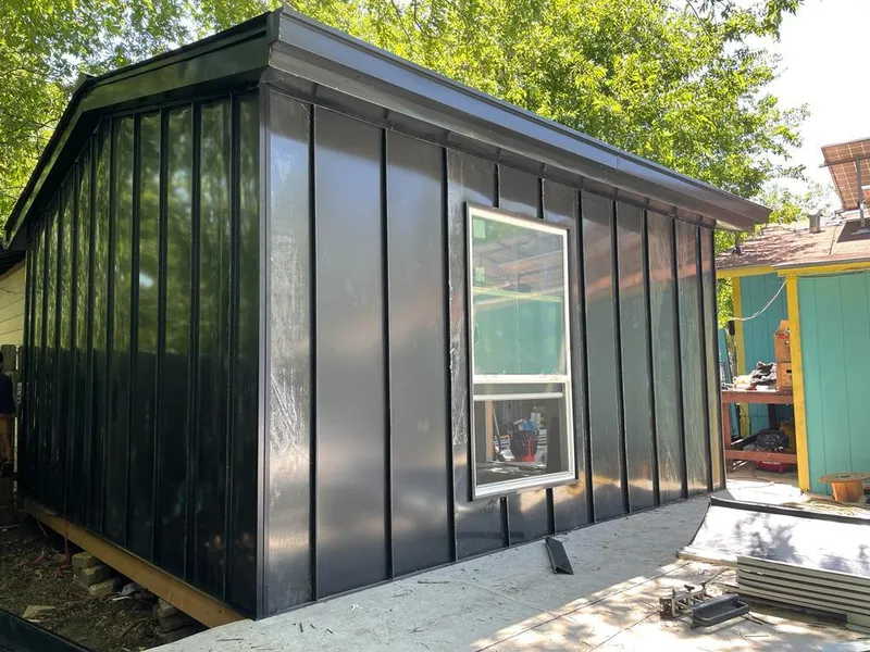 Black standing seam metal wall panels for Roof Inspection in East Rockaway