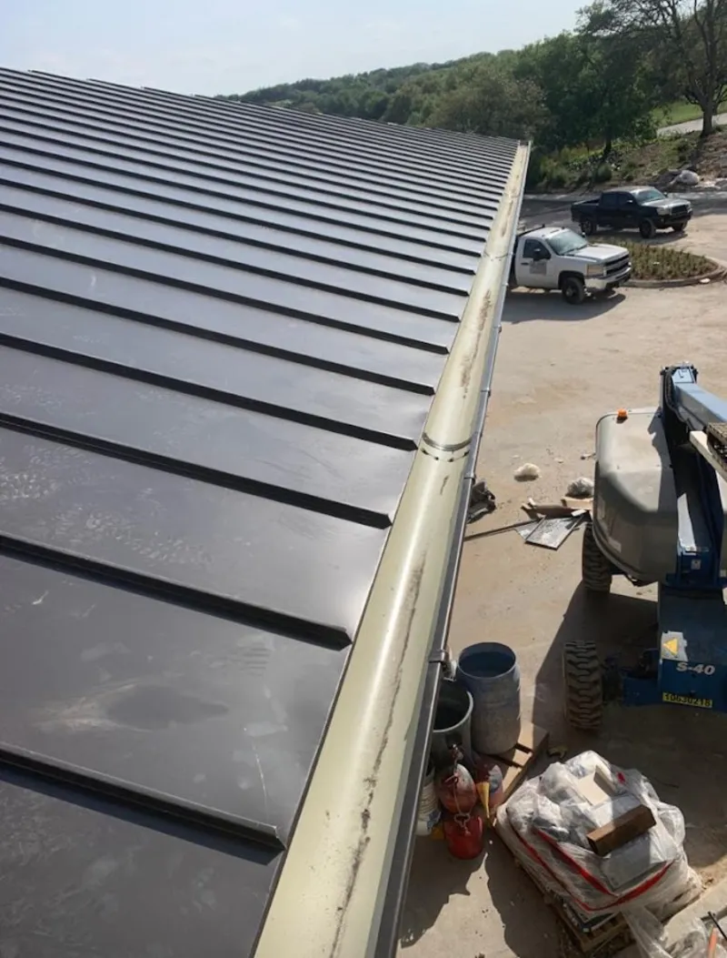 Standing seam panel and gutter detail on a metal roofing jobsite in East Rockaway